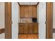 Inviting bar area featuring custom wood cabinets and a convenient countertop with modern fixtures at 817 S Creek Dr, Nashville, NC 27856