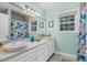 Bathroom with a double sink vanity, large mirror and natural light at 817 S Creek Dr, Nashville, NC 27856