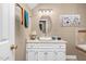 Bathroom featuring a white single sink vanity, decorative light fixture, and an oval mirror at 817 S Creek Dr, Nashville, NC 27856