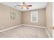 Bedroom featuring neutral carpet, a ceiling fan, a window and beige colored walls at 817 S Creek Dr, Nashville, NC 27856