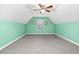 Cozy carpeted bedroom with mint green walls and ceiling fan at 817 S Creek Dr, Nashville, NC 27856