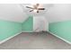 Spacious bedroom features sloped ceilings, neutral carpet, and a nearby doorway at 817 S Creek Dr, Nashville, NC 27856