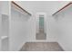 Walk-in closet with carpeted floor, shelving, and hanging rods at 817 S Creek Dr, Nashville, NC 27856