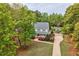 A lovely two-story home with mature landscaping, a long driveway, and a matching shed at 817 S Creek Dr, Nashville, NC 27856