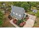 Aerial view of a two-story home with a charming porch, beautiful landscaping, and mature trees at 817 S Creek Dr, Nashville, NC 27856