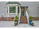 Welcoming home entrance with flower-filled planters and brick steps at 817 S Creek Dr, Nashville, NC 27856