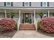 Inviting front porch featuring brick steps and decorative plants at 817 S Creek Dr, Nashville, NC 27856