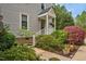 Charming covered front porch with lush landscaping and a colorful hanging basket at 817 S Creek Dr, Nashville, NC 27856