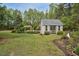 Charming outbuilding with French doors and surrounding landscaping at 817 S Creek Dr, Nashville, NC 27856