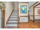Carpeted staircase with wood trim and railings at 817 S Creek Dr, Nashville, NC 27856