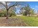 Expansive backyard featuring lush greenery, mature trees, and a storage shed for outdoor essentials at 8201 Rhodes Rd, Apex, NC 27539