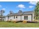 Renovated white home featuring a large wooden deck with sliding glass doors for indoor-outdoor living at 8201 Rhodes Rd, Apex, NC 27539