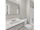 Clean, modern bathroom featuring updated vanity, mirror, and shower with grey accents at 8201 Rhodes Rd, Apex, NC 27539
