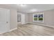 Bedroom featuring light tan walls, plush carpet and two windows for natural light at 8201 Rhodes Rd, Apex, NC 27539