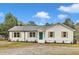 Charming single story home with white siding, wood shutters, and a vibrant blue front door at 8201 Rhodes Rd, Apex, NC 27539