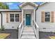 Close-up of a front porch with stone stairs and a teal front door with glass panes at 8201 Rhodes Rd, Apex, NC 27539