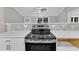 Close up shot of the stainless steel stovetop with white countertops and tile backsplash at 8201 Rhodes Rd, Apex, NC 27539