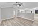 Open living room area with view of kitchen and bonus room at 8201 Rhodes Rd, Apex, NC 27539