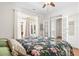 Bright bedroom with white walls, ceiling fan, doorway and sliding glass doors to the outside at 8525 Holdenby Trl, Raleigh, NC 27616