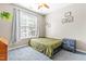 Neutral bedroom featuring a bed near the bright window, bedside table, and charming wall art at 8525 Holdenby Trl, Raleigh, NC 27616