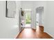 Welcoming entryway featuring gleaming wood floors, a stylish mirror, and a view of the front yard at 8525 Holdenby Trl, Raleigh, NC 27616