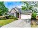 Beautiful home featuring a brick facade, well-maintained landscaping, and an attached two-car garage at 8525 Holdenby Trl, Raleigh, NC 27616