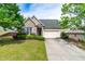 Charming home with well-manicured front yard, lush landscaping, and a convenient two-car garage at 8525 Holdenby Trl, Raleigh, NC 27616