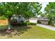 View of charming home and lush front yard with well-maintained landscaping and driveway at 8525 Holdenby Trl, Raleigh, NC 27616