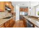 Well-equipped kitchen featuring stainless steel appliances, granite countertops, and ample wood cabinetry at 8525 Holdenby Trl, Raleigh, NC 27616
