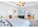 Bright main bedroom featuring tray ceilings, modern decor, and ensuite bathroom, with living room access at 8525 Holdenby Trl, Raleigh, NC 27616