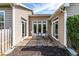 Cozy brick patio with table and chairs between two adjacent homes at 8525 Holdenby Trl, Raleigh, NC 27616