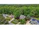An aerial view shows a landscaped yard, mature trees, and an attractive neighborhood setting at 928 Broadhaven Dr, Raleigh, NC 27603