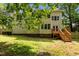 Large, grassy backyard provides ample space, complemented by a wooden deck and fencing at 928 Broadhaven Dr, Raleigh, NC 27603