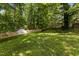Well-maintained backyard featuring green grass, a storage shed, and a privacy fence at 928 Broadhaven Dr, Raleigh, NC 27603