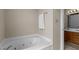 Modern white bathtub features jets and a pristine white towel on a brushed metal towel rack at 928 Broadhaven Dr, Raleigh, NC 27603