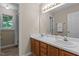Bathroom with double sinks, a large mirror, and a shower-tub combination at 928 Broadhaven Dr, Raleigh, NC 27603