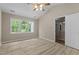 Bright bedroom with a ceiling fan, a vaulted ceiling, and a large window overlooking a green landscape at 928 Broadhaven Dr, Raleigh, NC 27603