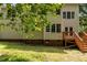 Rear exterior showcases the home's architecture with a backyard view and a wooden deck at 928 Broadhaven Dr, Raleigh, NC 27603