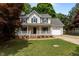 Charming two-story traditional home featuring a front porch, manicured lawn and attached garage at 928 Broadhaven Dr, Raleigh, NC 27603