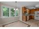 Eat-in kitchen with light wood cabinets, granite countertops and large windows overlooking the backyard at 928 Broadhaven Dr, Raleigh, NC 27603