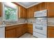 Eat-in kitchen with white appliances, tile backsplash and light wood cabinetry at 928 Broadhaven Dr, Raleigh, NC 27603