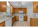 Kitchen with white appliances, tile floors and light wood cabinetry at 928 Broadhaven Dr, Raleigh, NC 27603