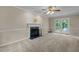 Inviting living room features a classic fireplace, ceiling fan, and glass doors to the outside deck at 928 Broadhaven Dr, Raleigh, NC 27603