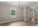 Carpeted Living room featuring a window, and traditional wainscotting at 928 Broadhaven Dr, Raleigh, NC 27603