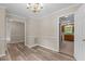 Living room featuring hardwood floors, neutral paint and traditional wainscotting at 928 Broadhaven Dr, Raleigh, NC 27603