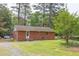 Charming brick home with well-maintained lawn, landscaping, and mature trees at 107 Glosson Cir, Carrboro, NC 27510