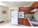 Functional kitchen featuring wooden cabinets and white appliances, ready for your culinary adventures at 107 Glosson Cir, Carrboro, NC 27510