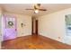 A bright living room with hardwood floors, a ceiling fan, and a distinctive violet interior door at 107 Glosson Cir, Carrboro, NC 27510