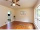 A sun-lit living room features hardwood floors and neutral wall paint with decorative accents at 107 Glosson Cir, Carrboro, NC 27510