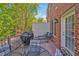 Brick patio with chairs and grill off the back of this charming home at 110 Tressel Way, Durham, NC 27707